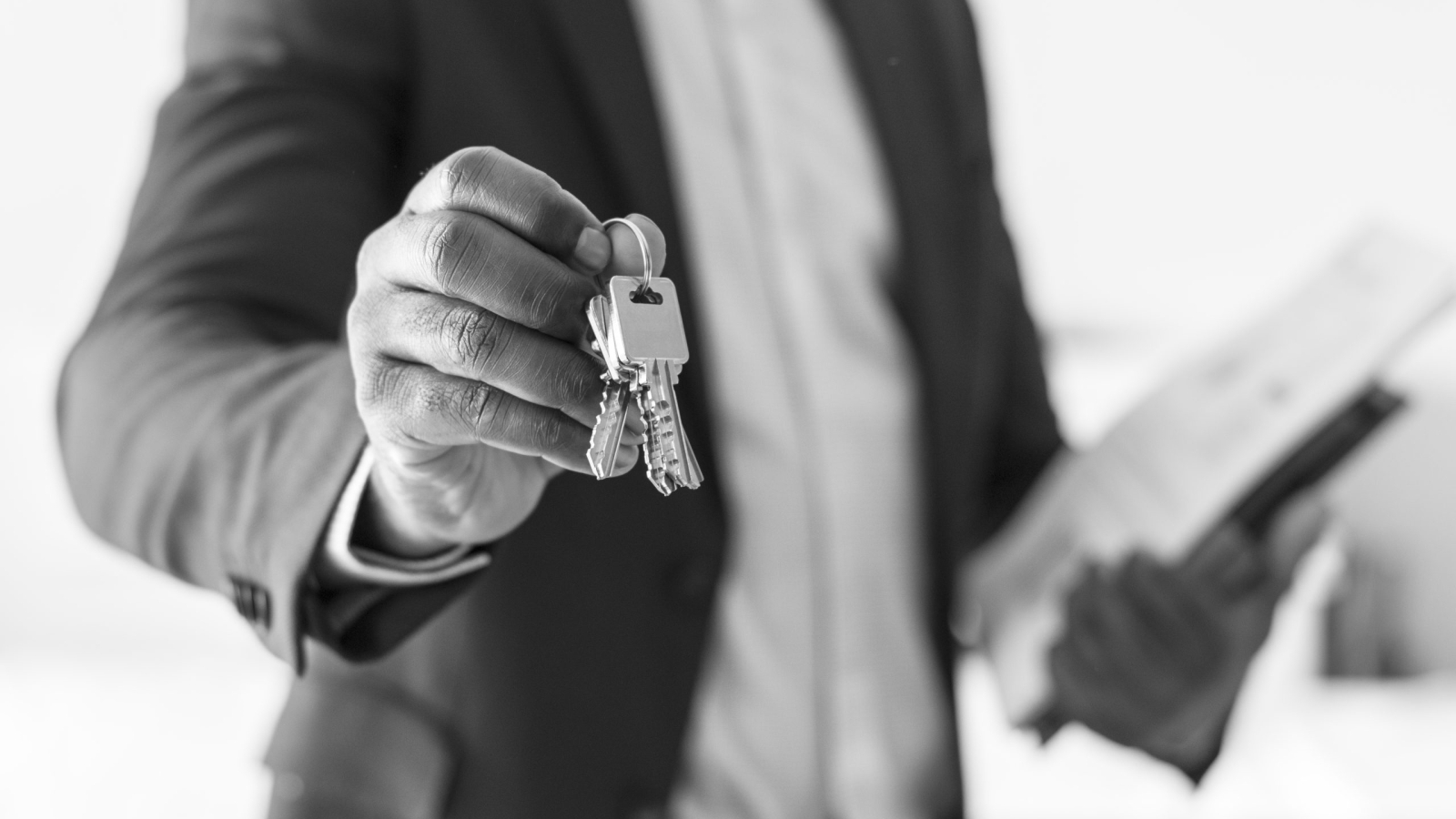 Real estate agent handing the house key