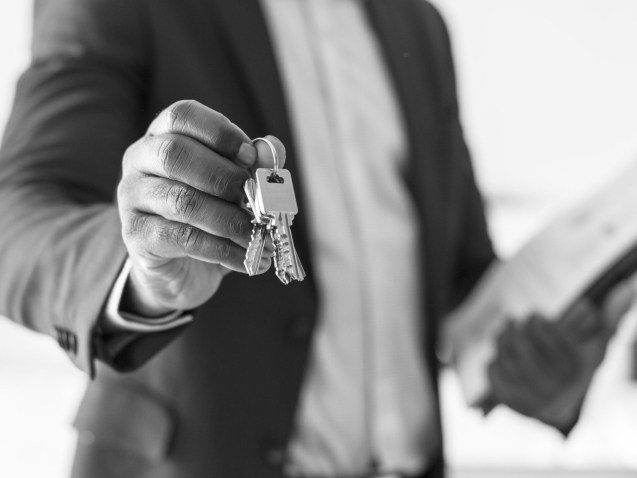 Real estate agent handing the house key